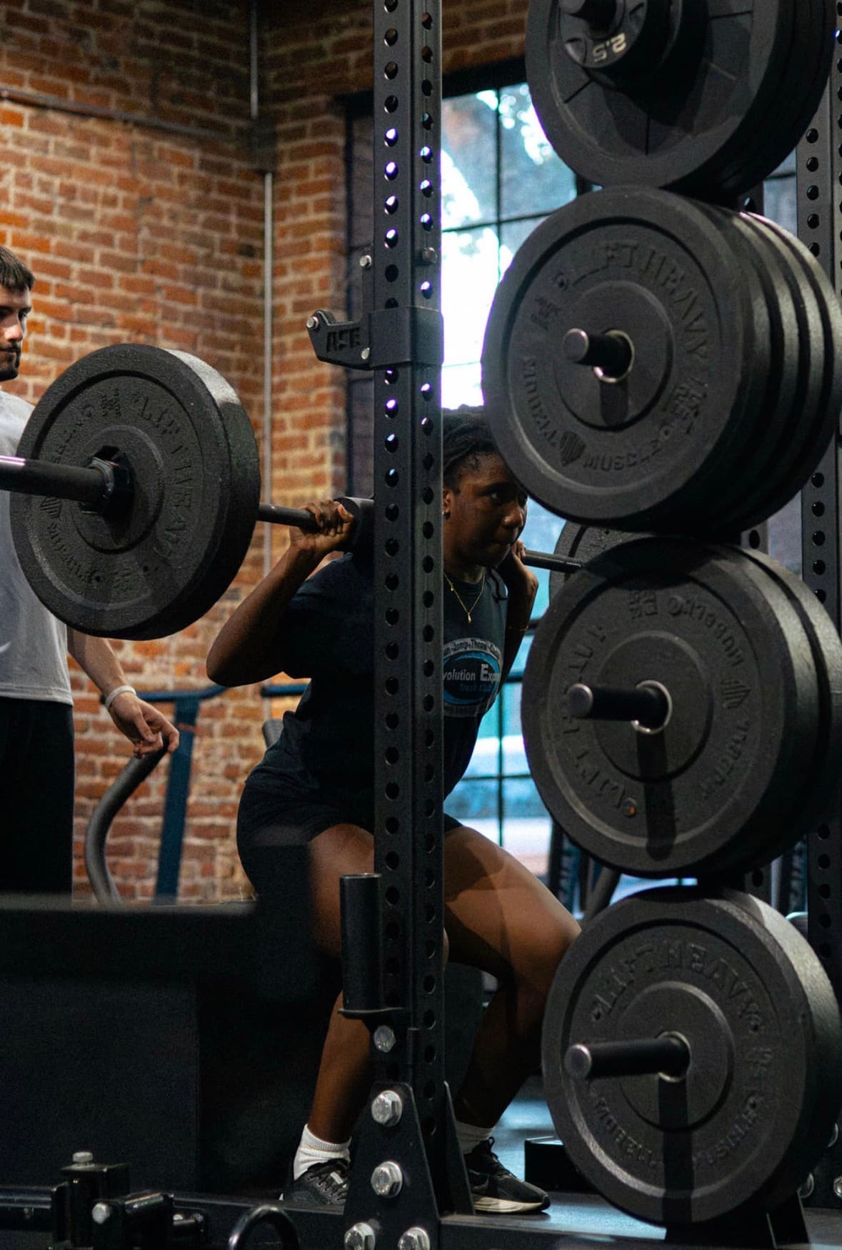 Athlete mid-squat under the guidance of a G6 coach in Sacramento